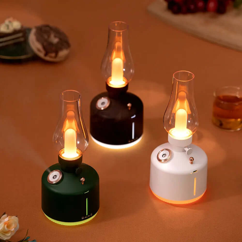 Three stylish flameless candles in green, black, and white creating a warm ambiance on a table setting.