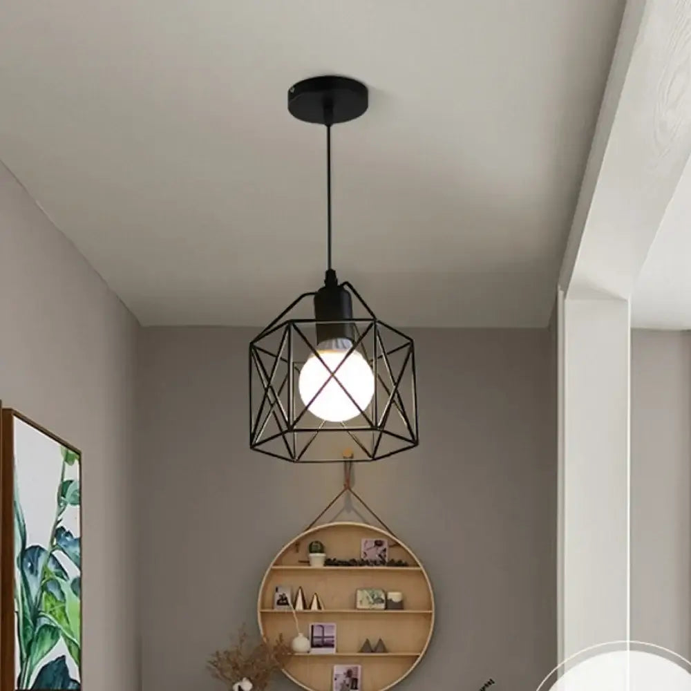 Modern black metal pendant chandelier with geometric design, illuminating a stylish interior space.